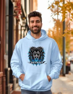 a man wearing a blue hoodie with an image of a lion on the front