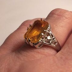 This Stunning Edwardian Victorian Vintage Mid-Century Avant-Garde Bohemian Gothic Celtic Style Ring Is A Show Stopper. 925 Sterling Silver. Size 8 4 Carats Of Citrine Stones. Citrine Is Associated With Positivity And Optimism, Which Is Not Surprising Given Its Cheerful Color. It's Often Used To Assist In Manifesting Financial Abundance And Opportunities. It Can Also Be Used To Awaken The Solar Plexus Chakra, Helping To Cultivate Confidence And Personal Power. 100% Authentic Stones, 925 Sterling Polished Silver Gemstones For Wedding, Silver Emerald-cut Topaz Ring With Gemstone Accents, Wedding Silver Polished Gemstones, Formal Citrine Gemstones With Center Stone, Elegant Amber Topaz Ring, Formal Orange Sterling Silver Rings, Silver Citrine Jewelry With Accent Stones, Polished Silver Gemstones For Anniversary, Classic Silver Topaz Ring With Gemstone Accents