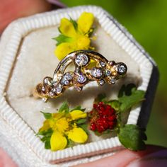 This sparkly ring design is our new Rainbow & Cloud ring (but the largest diamond represents the "sun") in 14K gold and encrusted with diamonds. This piece is imbued with sunshine and joy. A rainbow and sparkling diamonds are set into bubbly "clouds", an abstract representation of sunshine and joy after the rain. Nicole created this ring with different methods of ancient goldsmithing and fusing and then created a mold so that we can recreate this in different 14K gold colors. It is truly a spiri Celestial 14k Gold Diamond Ring With Round Cut, Celestial 14k Gold Diamond Ring With Rose Cut Diamonds, Yellow Gold Crystal Ring With Diamond Accents For Promise, Dazzling Yellow Gold Cluster Ring For Promise, Dazzling 14k Gold Wedding Ring With Single Cut Diamonds, Heirloom Cluster Ring With Yellow Gold And Diamond Accents, Heirloom Cluster Ring With Diamond Accents In Yellow Gold, Heirloom Yellow Gold Cluster Ring With Diamond Accents, Celestial 14k Gold Jewelry With Prong Setting