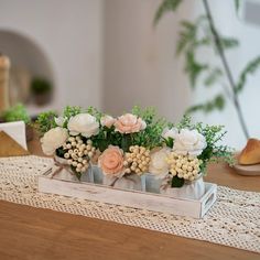 there are flowers that are in the vases on the table top, along with other things