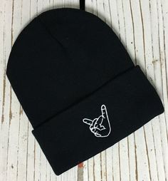 ROCK ON HAND Embroidered Beanie Cuffed Cap - Multiple Colors ✷ Cuffed Beanie with Embroidered Rock On Hand Sign ✷ Choose Color from Drop Down Menu ✷ One Size fits all ✷ 100% Acrylic ✷ Great fit and soft quality - Guaranteed! ✷ Still don't see the color combination you want? Just ask we can usually make it for you :) ✷ Shipping from Long Beach, CA ✷ Embroidered here at The One Stop Outlet ✷ If you have any questions or concerns please feel free to send us a message! ✷ Have a design idea of your o Punk Style Adjustable Beanie Hat, Adjustable Punk Beanie Hat, Adjustable Fit Hip Hop Hats For Winter, Hip Hop Beanie Cap One Size Fits Most, Adjustable Hip Hop Beanie Hat, Trendy Adjustable Beanie For Streetwear, Casual Black Hat For Music Festival, Rock On Hand Sign, Rock On Hand