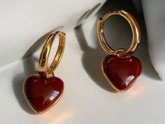 💖 Fall in love with these simple design wine red love heart dangle earrings! Their stunning heart shape in a rich wine red hue brings a romantic touch to any outfit, while the gold color circle adds a hint of elegance and charm. Perfect for adding a splash of color to your everyday style or making a statement on special occasions! ✨ These earrings gracefully sway with your movements, embodying a sense of playfulness and love. Whether you're out on a date or enjoying a night out with friends, th Elegant Red Heart Charm Earrings, Elegant Red Earrings With Heart Charm, Elegant Red Double Heart Earrings, Earrings Dangle Simple, Red Love Heart, Color Circle, Heart Dangle Earrings, Earrings Simple, White Heart