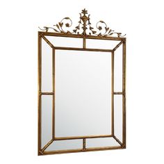 a mirror that is sitting on top of a wall with an ornate frame and gold trimming