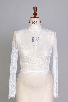 Beautiful lace top with long sleeves, perfect for the bride looking to enhance her wedding dress but it's also ideal for those who need of an extra layer either for the sake of appearing modest for a church ceremony or in chillier weather. Fabric samples are available for you to check the quality and to match the colour of your wedding dress. Link for the samples: https://www.etsy.com/uk/listing/1110356913/fabric-samples?click_key=12f16b37b8ed940454f859f9d61510ceed5a4a12%3A1110356913&click_sum=17247f9a&ref=shop_home_active_4&frs=1 We recommend steaming upon arrival and dry cleaning after use. If you like to make any changes to this style, feel free to contact me. Women Work Blouse, Wedding Shrug, Bridal Cover Up, Traditional Dresses Designs, Bridal Bolero, Lace Bolero, Bridal Tops, Shrugs And Boleros, Bridal Jacket