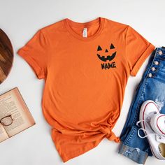 Custom Halloween Shirt, Pocket Size Halloween Shirt, Halloween Party Tee, Halloween T-shirt, Halloween Pumpkin Shirt, Matching Halloween How to Order?  1-Choose your t-shirt color, 2- Choose your size, 3- Select the quantity, 4- Click Add to Cart.  Production and shipping: * 100% airlume combed and ring-spun cotton, 32 singles 4.2 oz. * Solid colors are %100 cotton * Heathers are %52 cotton %48 polyester * Athletic Heather is combed and ring-spun cotton, 10% polyester * Seamless collar * Heat tr Orange Halloween T-shirt With Letter Print, Orange Crew Neck Top For Halloween, Fun Halloween T-shirt Pre-shrunk, Fun Halloween Pre-shrunk T-shirt, Fun Pre-shrunk Halloween T-shirt, Halloween Orange Graphic Print T-shirt, Orange Halloween Graphic T-shirt, Halloween Short Sleeve Pre-shrunk T-shirt, Halloween Short Sleeve Shirt With Direct Printing