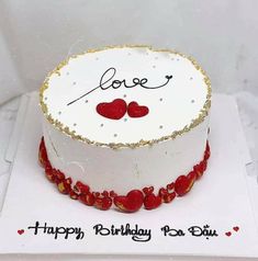 a birthday cake with two hearts on it