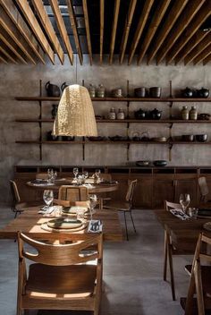 an empty restaurant with wooden tables and chairs