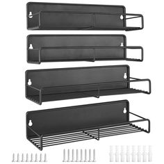 three black metal shelfs with hooks on each side and two white pegs next to them