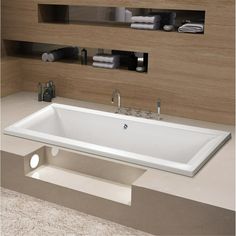 a large white bath tub sitting on top of a counter