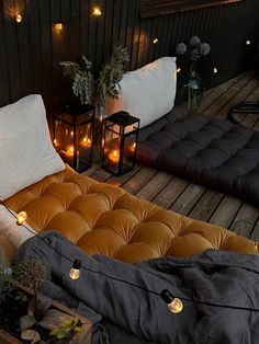 an outdoor lounge area with candles and pillows