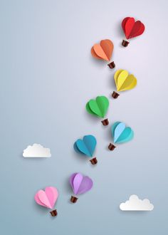 colorful hot air balloons floating in the sky with hearts cut out of paper on them