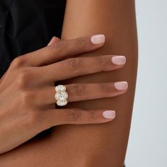 a woman's hand with a diamond ring on it