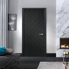 a modern living room with marble walls and flooring, including a black door that leads to an open fire place