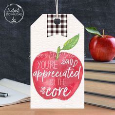 an apple is sitting on top of books with the words you're so appreciated to the core