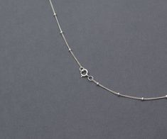 "925 Sterling Silver delicate satellite necklace a classic that will easily become one of your favorite! Makes a perfect gift! DETAILS: Chain - 925 Sterling Silver The same style in GOLD: https://www.etsy.com/listing/726646181/gold-satellite-chain-necklace-filled?ref=listings_manager_grid PACKAGING: All jewelry is packaged in a jewelry box ready for gifting. Comes with a polishing cloth to clean the sterling silver. ABOUT 925 STERLING SILVER: Use a polishing cloth to clean your silver items at t Minimalist Silver Charm Necklace With Satellite Chain, Silver Charm Necklace With Tiny Beads For Gift, Satellite Necklace, Virgin Mary Necklace, Silver Items, Curb Chain Necklace, Cubic Zirconia Necklace, Necklace Dainty, Lovely Jewellery