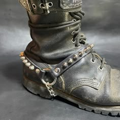 This bootstrap is available as a single or a pair.  Handmade from genuine leather and adorned with a single row of small UK 77 studs. Adjusts around your boot with a single buckle and under-the-boot chain.  Made to Order - please allow up to 6 weeks for processing and production. Feel free to message me if you have any questions! Praetorian Jack, Joel Core, Boot Chains, Hot Boots, Boot Straps, Rochester Ny, Suspender Belt, Goth Outfits, Sock Shoes