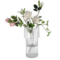 a glass vase filled with white and pink flowers