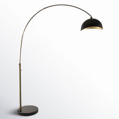 a black and gold floor lamp on a white background with the light turned off to show its dim lighting