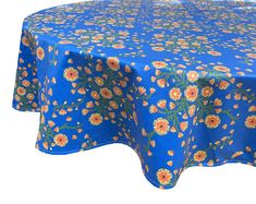 a blue table cloth with yellow and orange flowers on it, against a white background