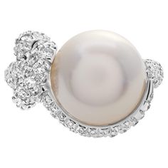 Mikimoto Milano South Sea pearl ring with a high grade, excellent luster and round shape. Pearl is 11.8mm with very clean surface with strong lacre with silver body and rose overtone. Approximately 2 carats of diamond accents in total. Width at shank: 4.0mm. This Pearl/diamond ring is currently size 6 and some items can be sized up or down, please ask! It weighs 6.7 pennyweights and is 18k White Gold. Luxury White Gold Pearl Ring With Halo Setting, Luxury White Gold Pearl Ring With Single Diamond, Luxury Antique White Gold Pearl Ring, Luxury White Gold Pearl Ring With Polished Finish, Mikimoto Pearl Ring, Luxury Exquisite Round Cut Pearl Ring, Luxury High Luster Silver Pearl Ring, Wide Diamond Rings, Sea Rings