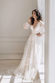 a woman in a wedding dress posing for the camera