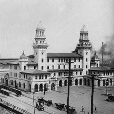 an old black and white photo of a large building with two towers on each side