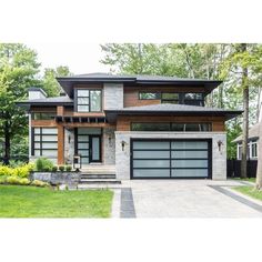 a modern house with two garages in the front yard