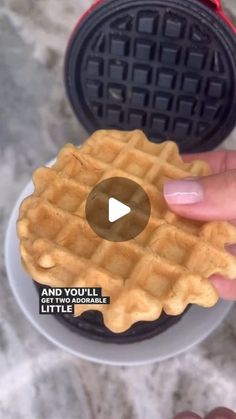 a person holding a waffle in their hand