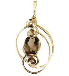 Indulge in the fine jewelry of a bygone era with this classic 65 Smoky Quartz wire sculpted pendant. Spirals of 14K Gold-filled wire encase a stunning Smoky Quartz gemstone that accents this luxurious design. Approximately 65 carats Measures approximately 4 1/2 Inches in Length x 2 Inches in Width; Bail 1/4 Inches in Width Chain not included 14K Gold-filled Gift Boxed Smoky Quartz Pendant, Wire Wrapped Jewelry Diy, Lapis Pendant, Wire Wrapping Stones, Jewelry Showcases, Diy Wire Jewelry, Bracelet Argent, Quartz Pendant, Wrapped Pendant