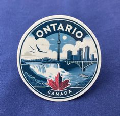 a sticker with the words ontario on it and a canadian maple leaf in front of a cityscape