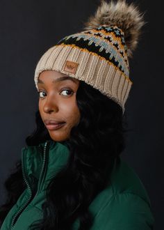 a woman wearing a winter hat and green jacket