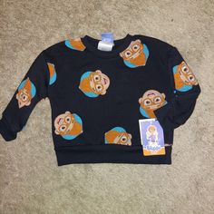 This Blippi Fleece Pullover Sweatshirt Is The Perfect Blend Of Warmth And Whimsy. The Long-Sleeve Sweatshirt Is Made Of A Midweight Cotton Blend With Ribbed Edges For Toasty Warmth And A Crisp Look. An Allover Print Of Playful And Colorful Faces Of Blippi On A Black Background Takes The Simple Crewneck Sweatshirt To The Next Level, Giving Your Little One The Cutest Choice To Flaunt Their Fandom. Simple Crewneck, Long Sleeve Sweatshirts, Toddler Boys, Pullover Sweatshirt, Black Background, Kids Shirts, Black Backgrounds, The Cutest, Little One