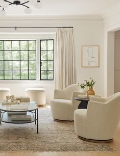 a living room filled with furniture and windows