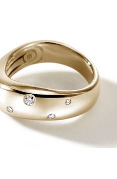 a gold ring with three diamonds on it