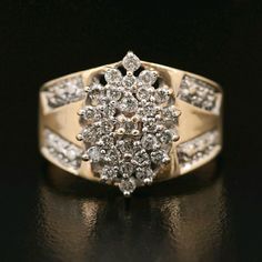 a yellow gold ring with white diamonds on black background, close up view to the center