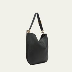 TOM FORD "Tara" crossbody hobo bag in leather, faux leather (polyurethane), and brass  Adjustable, detachable flat crossbody strap Open top with T-strap magnetic closure; zip closure  Lining: Polyurethane Approx. 15"H x 15.7"W x 1.6"D Item Weight (Lbs.): 1.9 Made in Italy Modern Crossbody Hobo Bag With Gold-tone Hardware, Versatile Hobo Bag With Gold-tone Hardware, Versatile Hobo Bag With Gold-tone Hardware For Work, Modern Hobo Bag With Gold-tone Hardware For Daily Use, Modern Hobo Bag With Gold-tone Hardware For Business, Workwear Hobo Bag With Metal Hardware Crossbody, Workwear Hobo Shoulder Bag With Metal Hardware, Modern Hobo Bag With Metal Hardware For Daily Use, Modern Crossbody Hobo Bag With Metal Hardware