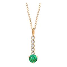 This is part of Chairish’s Fine Jewelry assortment.  The Emerald and Diamond Lariat Gold Drop Necklace Pendant features a blend of elegance and sophistication. Crafted from fourteen karats of white and yellow gold, this trending lariat necklace pendant exudes luxury. Here are the key details: Gemstones: The pendant showcases a single round emerald, bezel set and weighing 0.40 carats. The emerald exhibits a hue tone resembling grass green, adding a vibrant touch to the piece. Additionally, there Elegant Yellow Gold Lariat Necklace With Gemstone, Gold Drop Necklace, Diamond Drop Necklace, Diamond Jewelry Necklace, Diamond Bar, Diamond Chain, Grass Green, Diamond Drops, Key Details