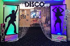 an entrance to a disco themed party with lights and decorations on the sides, featuring silhouettes of dancers