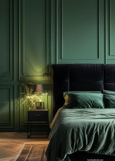 a bed with green sheets and pillows in a room that has green walls, wood floors and wooden flooring