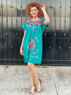 "Mexican embroidered dress women, hand embroidery tunic, cotton short sleeve summer dress, boho hippie sundress, tropical vacation, frida A very bright and fun traditional Mexican dress, short sleeve, teal and multicolor hand embroidered flowers. Great piece to wear in spring, summer, mexican festivities or if you go to a Mexico destination vacay. Loose fit Made of Cotton Fits size SMALL (maybe Medium, check measurements) Measurements taken flat: - Armpit to armpit 21 1/2\" - Bottom hem width 23 Summer Sundress With Floral Embroidery For Vacation, Embroidered Cotton Mini Dress For Vacation, Bohemian Sundress With Floral Embroidery, Embroidered Boho Summer Dress, Casual Embroidered Boho Dress For Vacation, Embroidered Short Sleeve Dresses For Summer, Floral Embroidered Dress For Beach, Short Sleeve Embroidered Vacation Dress, Embroidered Sundress For Beach