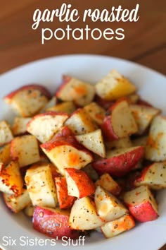 there is a white plate with potatoes on it and the words garlic roasted potatoes above it