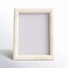 an empty white square frame on a plain surface with light reflection in the center and bottom corner