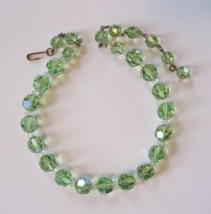 ❘❘❙❙❚❚ ON SALE ❚❚❙❙❘❘ until 12/20/20 at 11:00PM This is a lovely Accessocraft NY spring green crystal set. I think this color might actually be called chrysolite. It is not the usual green you see in crystals or rhinestones, a very sweet spring green color. The necklace was missing a hook, so I replaced it with a vintage hook in brass. The earrings are marked "Accessocraft NY" on the adjustable clip screw tops. The necklace is 13 inches long with an additional 3 1/2 inches of chain for adjustmen Green Round Crystal Jewelry, Green Crystal Jewelry For May Birthstone, Elegant Green Faceted Crystal Necklaces, Green Faceted Beads Jewelry For May Birthstone, Green Faceted Bead Jewelry For May Birthstone, Elegant Green Crystal Necklace With Faceted Beads, Vintage Green Jewelry With Faceted Beads, Vintage Green Crystal Jewelry, Green Round Beads Costume Jewelry