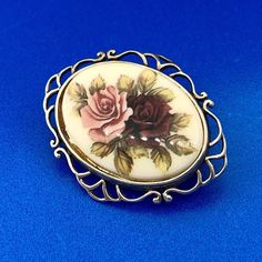 * Vintage Hallmarked Sterling Silver 925 Oval Floral Enamel Open Work Pin Brooch * Length: 1-3/4" * Width: 1-1/16" * Oval enamel measures: 1.0" x 3/4" and depicts one red and one pink rose bouquet * Weight: 5.3 tgw * Marked: Makers Mark*925*Hallmark * Condition: Great * S783    Exported By ExportYourStore :) Ornate Oval Brooches For Anniversary, Oval Cabochon Brooches For Anniversary, Ornate Oval Anniversary Brooches, White Oval Brooch For Anniversary, Classic Oval Brooches For Collectors, Vintage Enamel Brooches For Anniversary, Vintage Enamel Oval Pendant Jewelry, White Oval Brooches For Gifts, Vintage Oval Enamel Jewelry