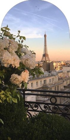 the eiffel tower is seen through an arched window in this cityscape