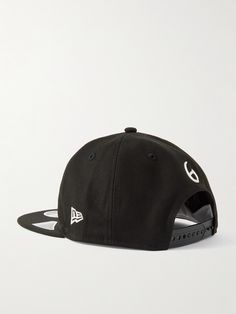 SAINT Mxxxxxx has collaborated with New Era on this baseball cap, a brand that has specialised in the category for about a century. It’s made from twill in the brand's '9FIFTY' profile and embroidered with a mascot on the front. Black Hat With Logo Print And Flat Brim, Snapback Hat With Logo For Streetwear, Logo Detail Snapback Hat For Streetwear, Streetwear Hat With Logo Detail And Curved Brim, Streetwear Hat With Curved Brim And Logo Detail, Snapback Hat With Logo Detail For Streetwear, Logo Six-panel Baseball Cap For Streetwear, Streetwear Baseball Cap With Logo And Curved Visor, Curved Visor Baseball Cap With Logo For Streetwear