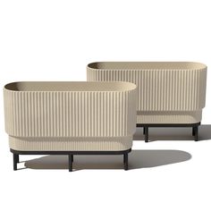 two white planters sitting next to each other