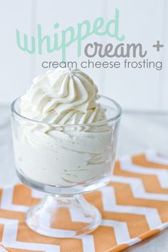 whipped cream and cream cheese frosting in a small glass dish on an orange chevron napkin