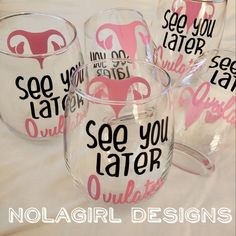 four wine glasses with pink and black designs on the bottom one is clear, the other has white lettering that says see you later