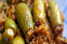 some green beans and rice on a blue plate with a white checkered table cloth